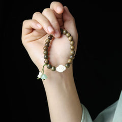Green Sandalwood Bead Bracelet with Floral and Jade Charms