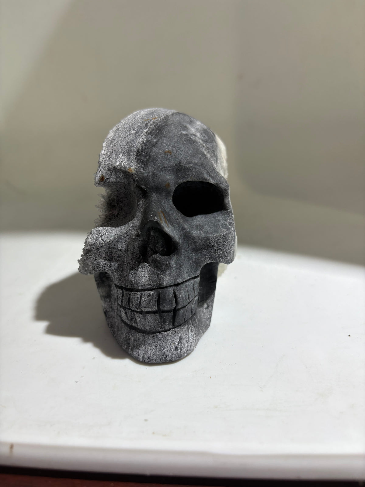 Dual-Tone Calcite Crystal Skull Stone Sculpture with Natural Quartz Cluster